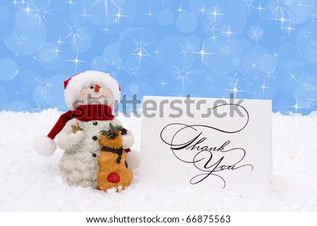 A snowman with a thank you card on a snow background, Winter time