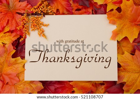 Happy Thanksgiving Message, Autumn Leaves with a beige greeting card with text with gratitude at Thanksgiving