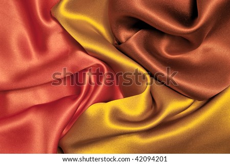 Elegant and soft red, yellow, brown satin background.