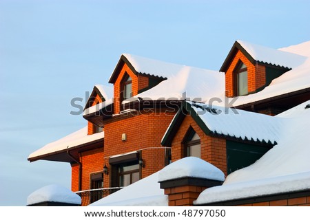Roof of residential house in winter with snow.