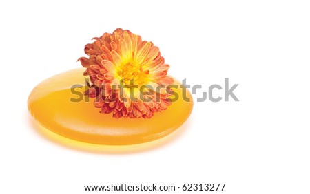 Natural orange soap and flower isolated on white background.