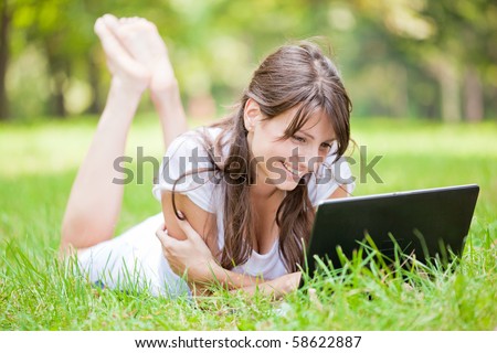 Beautiful young woman using laptop at outdoor