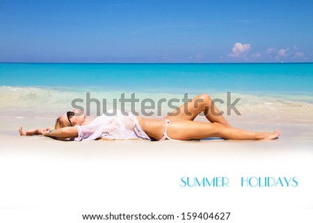 Cute girl runs out of the sea with water splash, beautiful clean beach, luxury resort in the Cuba, summer holidays concept