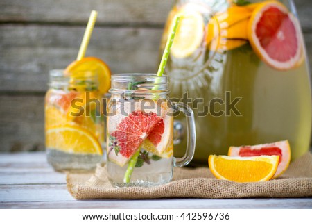 Preparation of the lemonade drink. Lemonade in the jar on the table outdoor