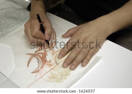 Drawing a tattoo. assistant