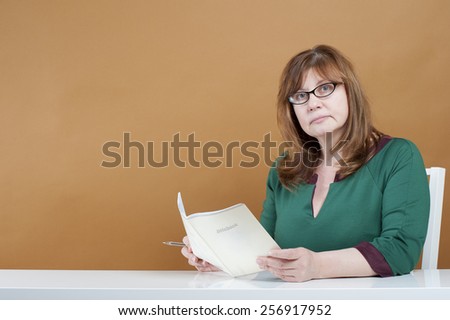 Woman teacher checks the notebook.