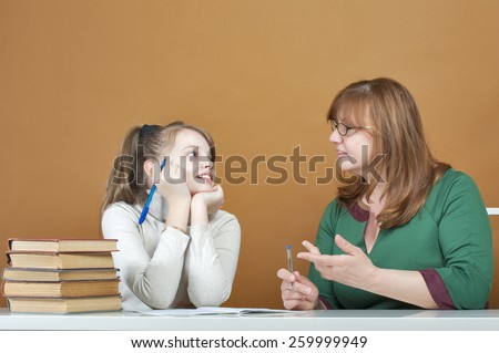 Woman teaches a ten-year girl.