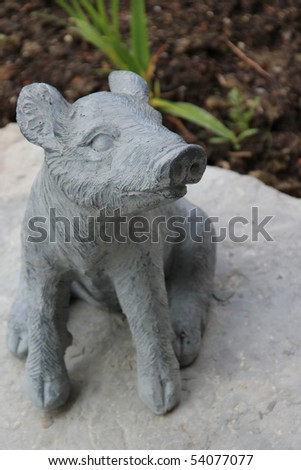 A ceramic pig pottery in the colors of nature, grey and brown