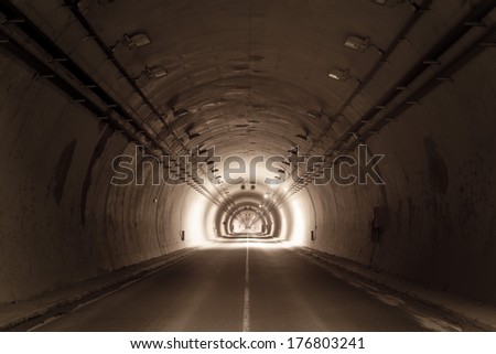 road tunnel tinted brown with lights and road line