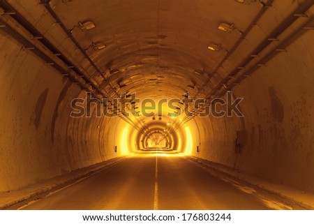 road tunnel tinted yellow with lights and road line