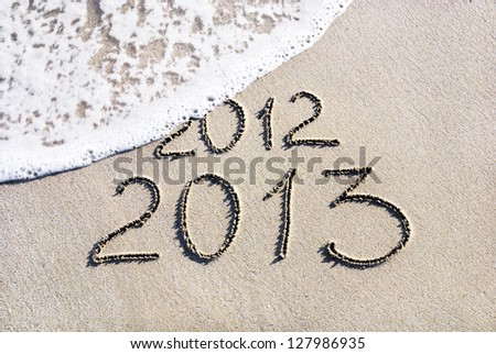 Happy New Year 2013 replace 2012 concept on the sea beach