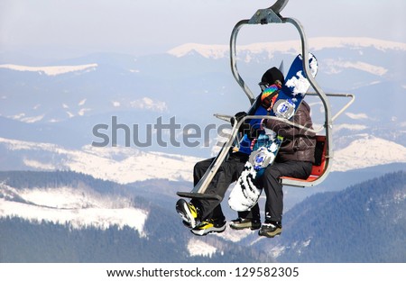 Skiers couple on a ski lift