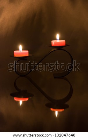 candlestick in from of the heart wint two candles make the romantic atmosphere