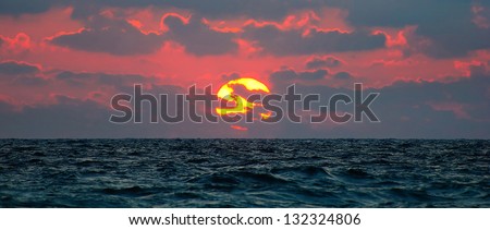 cloudy sunset panorama under the sea waves surface