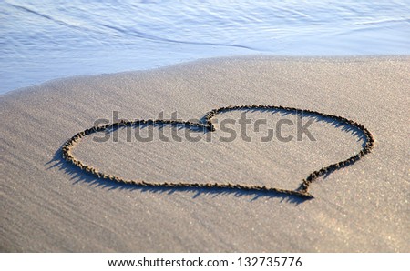heart outline on the wet brilliance sand