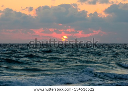 cloudy sunset panorama under the sea waves surface
