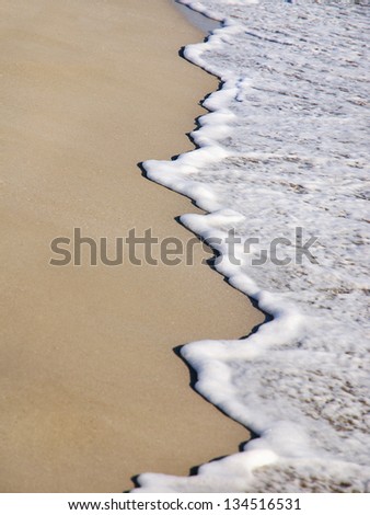 Sand beach and sea wave vertical background