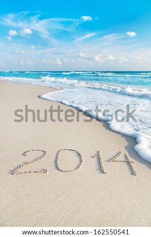 Inscription 2014 On Sea Sand Beach With The Sun Rays Against Wave Foam And Sky - Vacation Concept