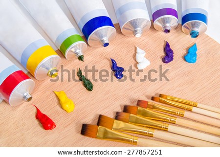 Oil paints tubes and paint brushes on a artist palette