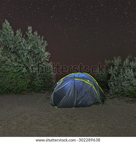 Camping tent under night starry sky. Outdoor Camping adventure.