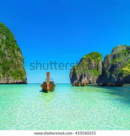 Thailand exotic beach view with traditional longtail boats against steep limestone hills after flood tide, Maya Bay, Ko Phi Phi Lee island, Phi Phi archipelago, part of Krabi Province, Andaman Sea