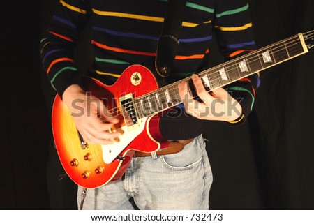 Playing a classic sunburst pattern electric guitar. Good hand position.