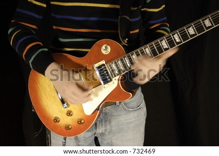 Playing a classic electric guitar fast. Hand movement on neck.