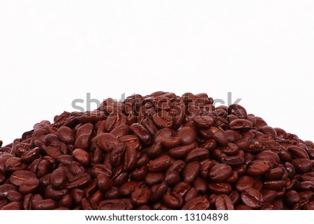 A pile of Colombian Coffee beans on the lower third of a white background.