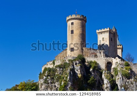 medieval stone castle on a high mossy rock