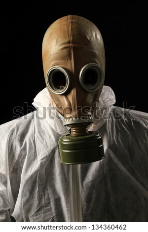 scary man with no eyes in full protective clothing wearing a gas mask.