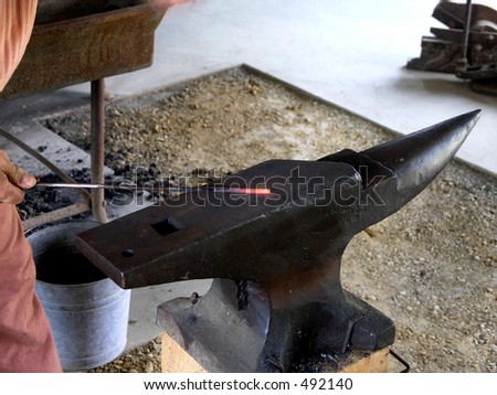 Strike while the iron is HOT (red hot)!  Blacksmith makes item on anvil of wrought iron.  Anvil is iconic of industrial power etc.