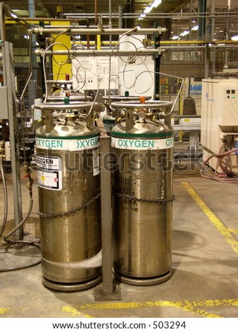 Factory floor oxygen cylinders used in industrial processes.