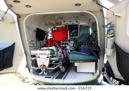The inside of a medical helicopter is filled with emergency life support equipment.