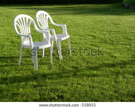 Chairs set out in the lawn at evening symbolize relaxation after a day of hard work