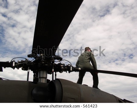 Sitting atop the main rotor blades this mechanic is taking some time off