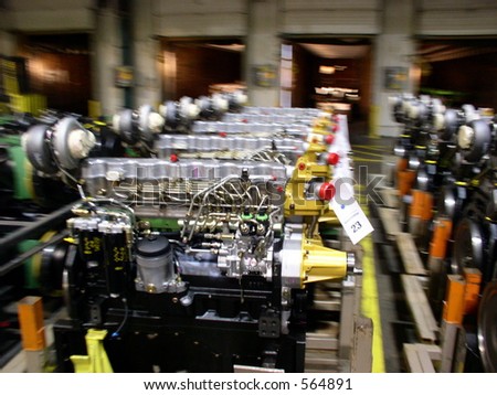 Factory floor in automotive plant has row after row of new engines waiting to be installed