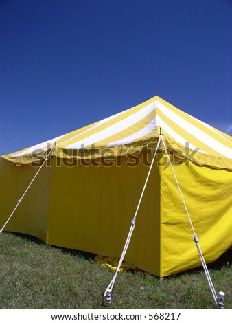 Yellow carnival tent against blue sky