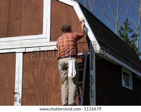 Man on Ladder Painting Building with Brush