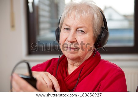 female senior listening music