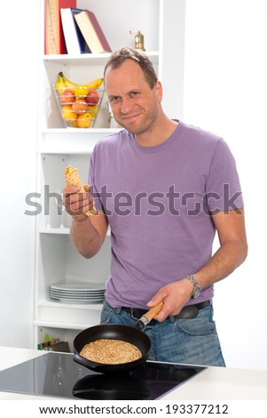 man is cooking pancake