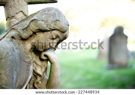 female sculpture on cemetery