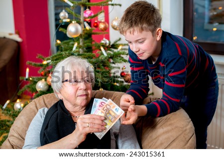 female senior has a money gift for her grandson