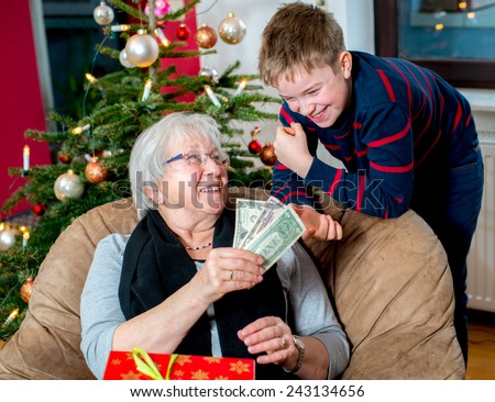 female senior has a money- gift for her grandson