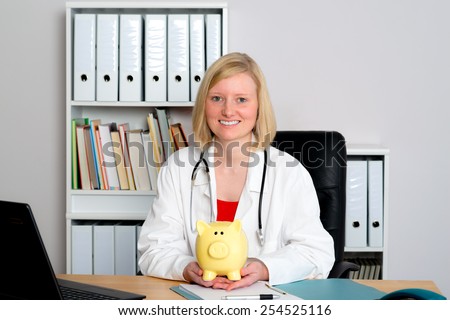 young female family doctor in her office with a piggy bank