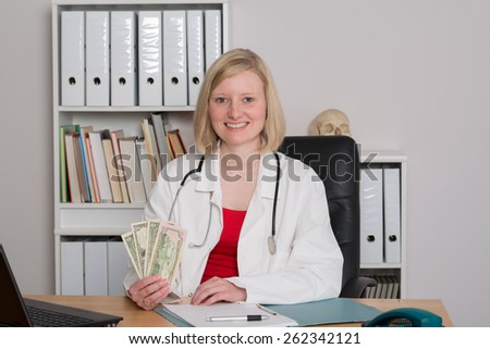 young female family doctor in her office with money