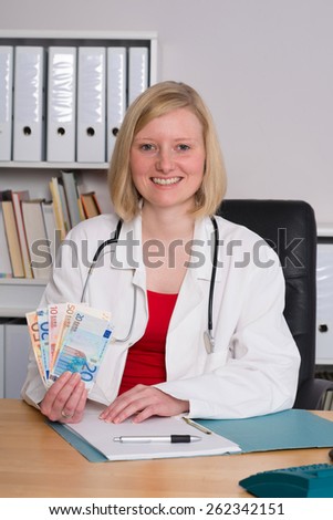 young female family doctor in her office with money