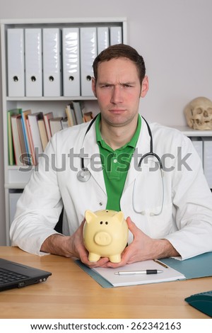 young doctor in her office with piggy bank is angry