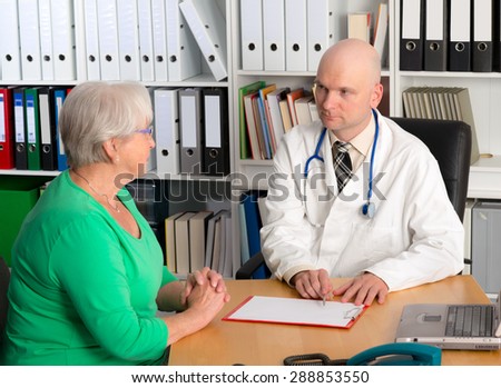young family doctor in interview with a female senior
