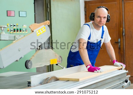 worker with ear protector in a carpenter\'s workshop