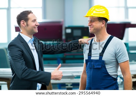 young boss is lauding worker in factory